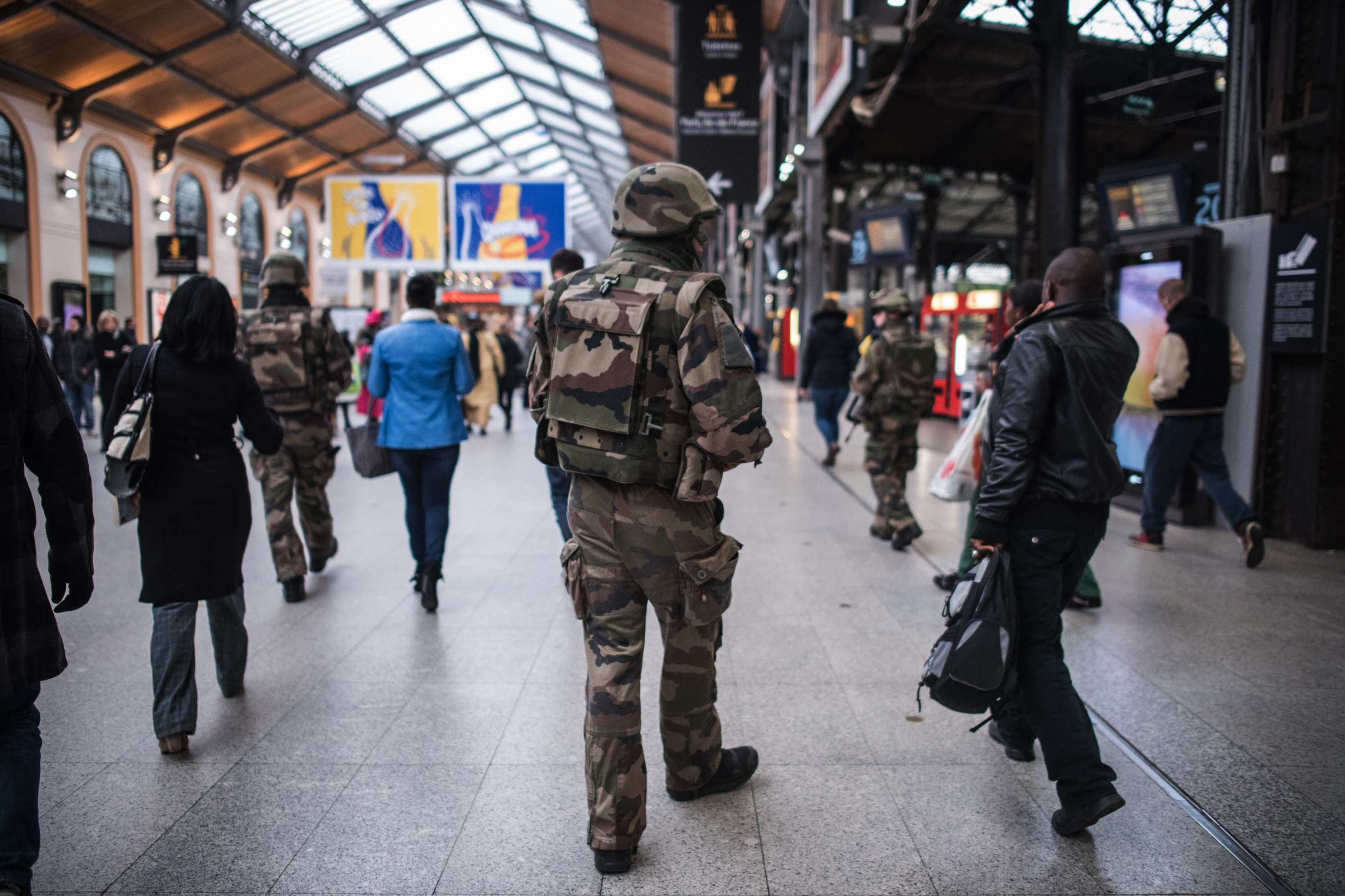 A French soldier patrols at Gare Saint Lazare train station in Paris, Saturday, Nov. 15, 2015. French President Francois Hollande vowed to attack Islamic State without mercy as the jihadist group admitted responsibility Saturday for orchestrating the deadliest attacks inflicted on France since World War II. (AP Photo/Kamil Zihnioglu)/ZIH102/225136091837/1511141246